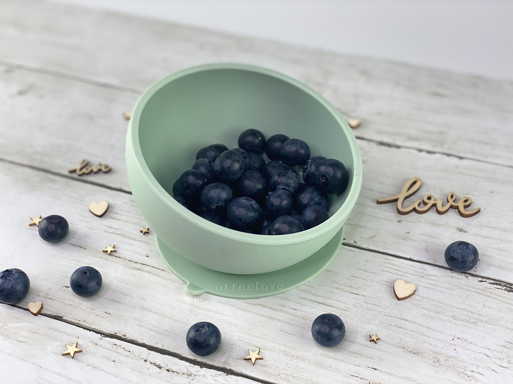 ergonomic silicone baby feeding bowl with suction base - sage - healthy toddler snacks - blueberries