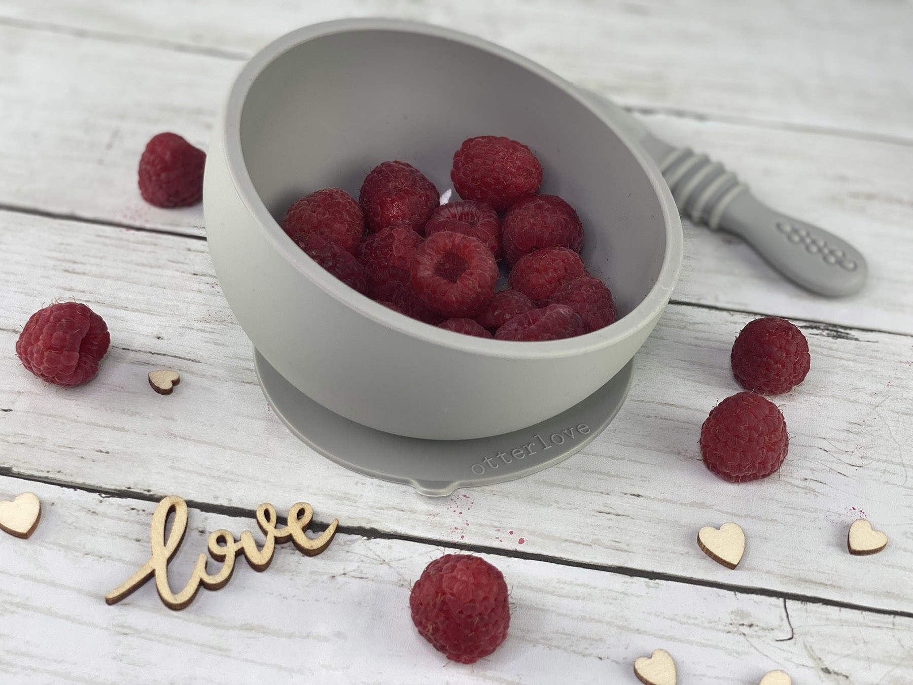 ergonomic silicone baby feeding bowl with suction base - sand - healthy toddler snacks - raspberries
