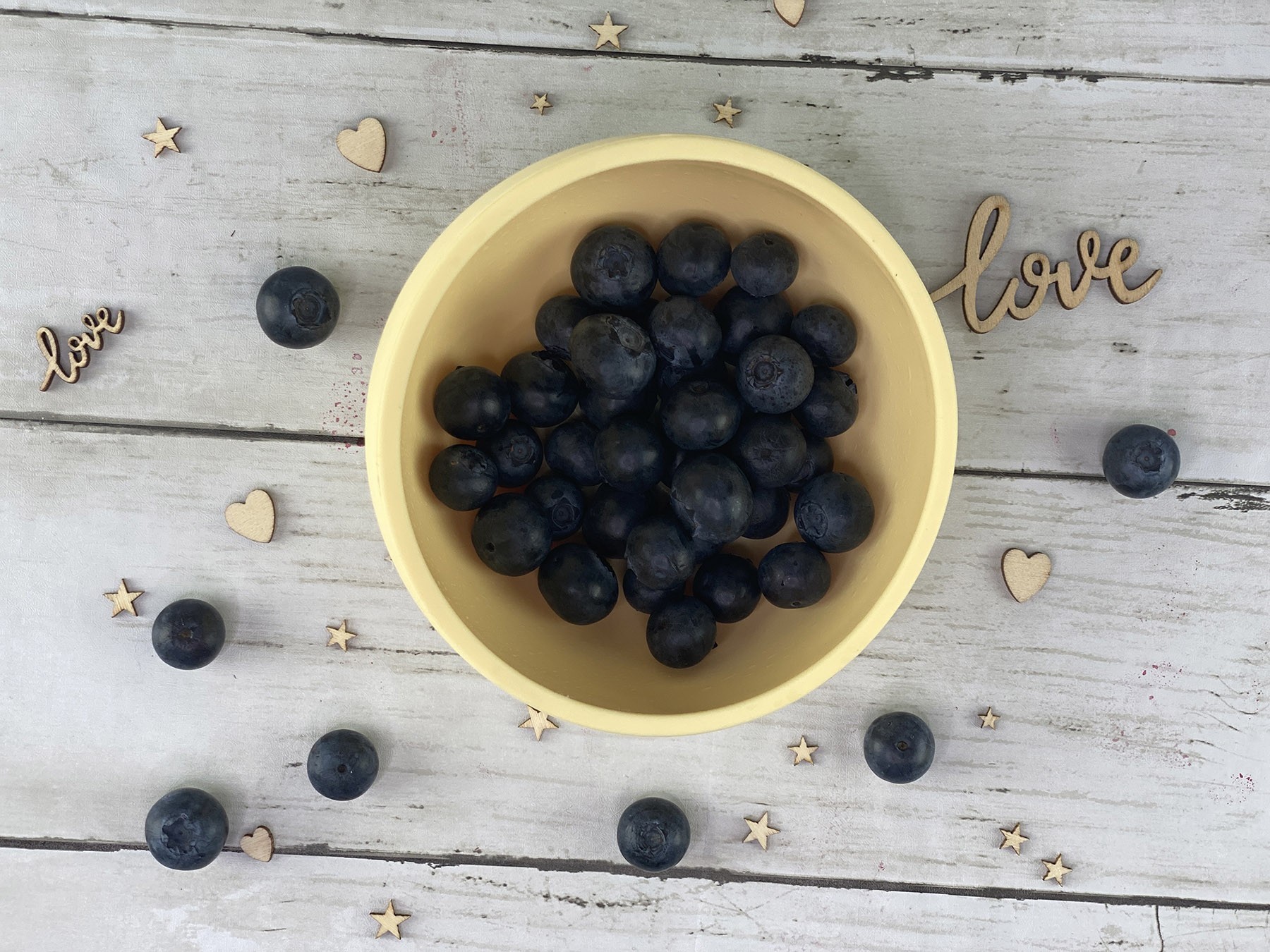 ergonomic silicone baby feeding bowl with suction base - sunshine - healthy toddler snacks - blueberries