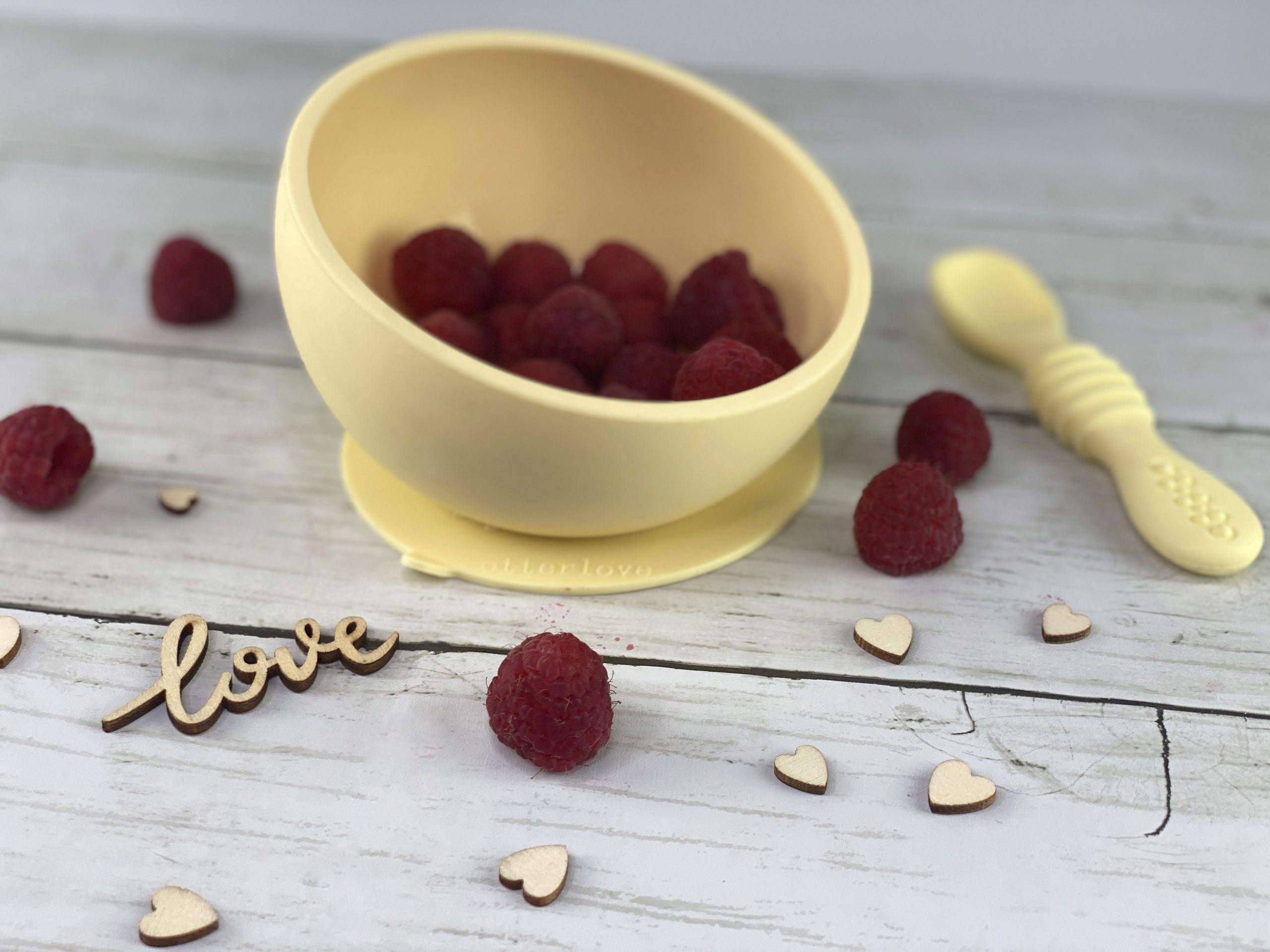 ergonomic silicone baby feeding bowl with suction base - sunshine - healthy toddler snacks - raspberries